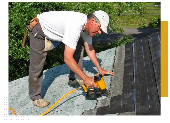 Man installing new roof shingles.