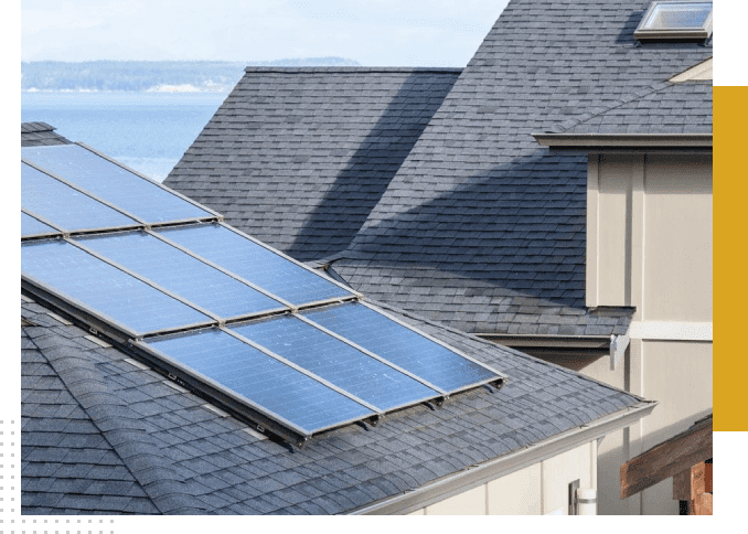 Solar panels on a grey shingled roof.
